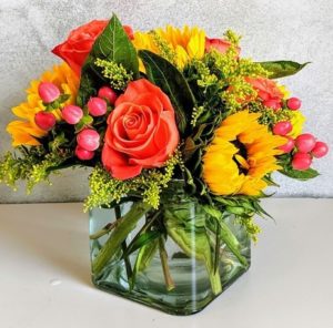 Brilliant Yellow sunflowers combined perfectly with orange roses, add a few hypericum berries and you have the perfect sunny flower delivery.